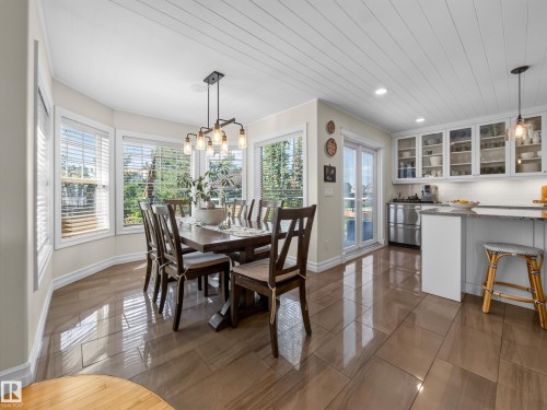 Wood-look tile flooring throughout, white shiplap ceiling, recessed lighting, and a linear pendant light fixture - 1223 Appleton Close, Sherwood Park, AB 