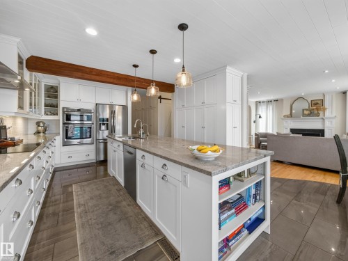 Kitchen featuring white shaker cabinetry, stainless steel appliances, a light-toned countertop, and recessed lighting - 1223 Appleton Close, Sherwood Park, AB 