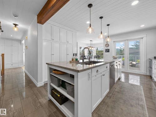 Kitchen island featuring a double basin sink and pendant lighting - 1223 Appleton Close, Sherwood Park, AB 