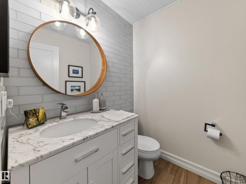 White vanity with a marble-finish countertop, undermount sink, and chrome faucet - 1223 Appleton Close, Sherwood Park, AB 