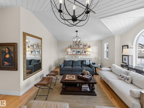 Vaulted ceiling with white wood paneling, hardwood flooring, and an arched window - 1223 Appleton Close, Sherwood Park, AB 
