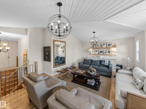 Angled plank ceiling with exposed beams, hardwood flooring, and wrought iron balusters - 1223 Appleton Close, Sherwood Park, AB 