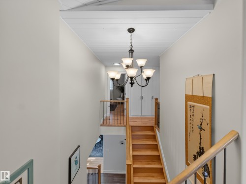 Multi-level staircase featuring natural wood steps and railings with metal balusters - 1223 Appleton Close, Sherwood Park, AB 