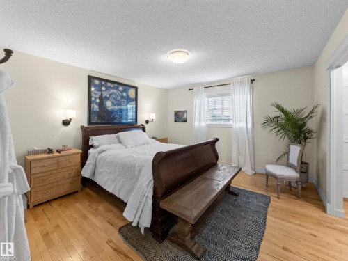 Light wood-finish flooring, recessed lighting, wall-mounted sconces, and a window with blinds - 1223 Appleton Close, Sherwood Park, AB 