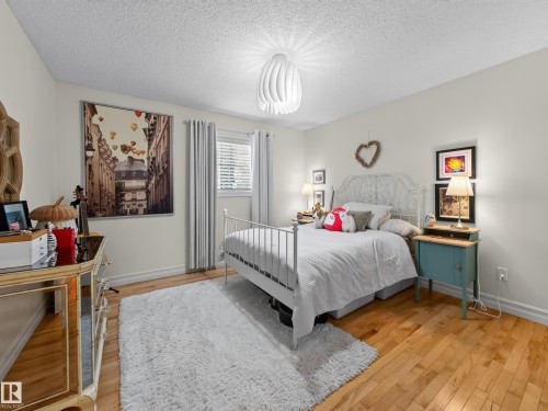 Natural wood-finish flooring, white walls, window with blinds, and ceiling-mounted light fixture - 1223 Appleton Close, Sherwood Park, AB 