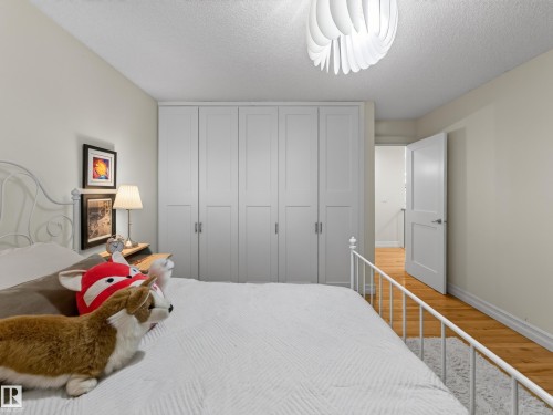 Built-in paneled cabinetry, wood-finish flooring, white painted walls, and a modern ceiling fixture - 1223 Appleton Close, Sherwood Park, AB 