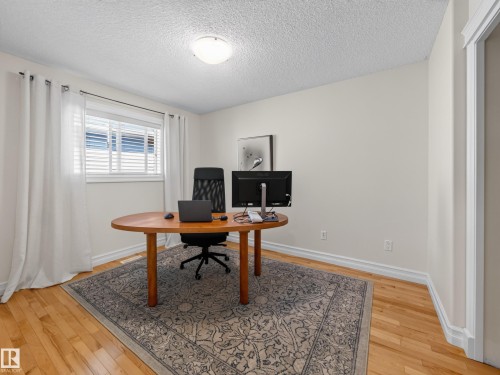 Wood-finish flooring, white walls, and a window with horizontal blinds and white trim - 1223 Appleton Close, Sherwood Park, AB 