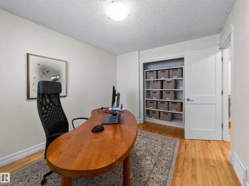 Hardwood flooring, built-in shelving, white trim, and a flush mount ceiling light - 1223 Appleton Close, Sherwood Park, AB 