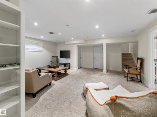 Recessed lighting illuminates the carpeted floor, built-in shelving, and white interior doors - 1223 Appleton Close, Sherwood Park, AB 