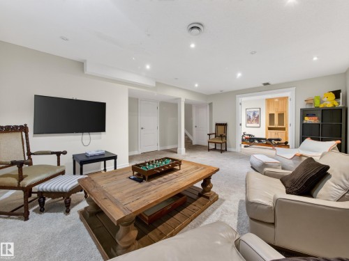 Carpeted flooring, recessed lighting, white trim, light-colored walls, and a separate room with wood-finish cabinetry - 1223 Appleton Close, Sherwood Park, AB 