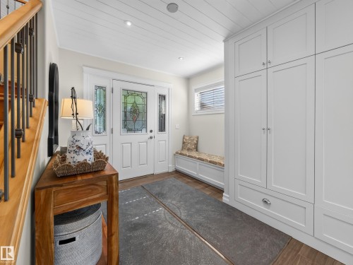 Entryway featuring a decorative transom, side lights with leaded glass, and wood-finish flooring - 1223 Appleton Close, Sherwood Park, AB 
