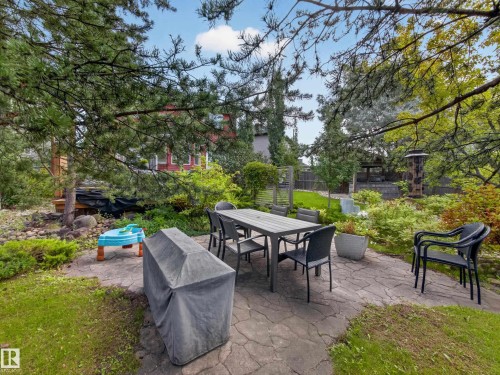Stone patio area, surrounded by mature trees and varied landscaping - 1223 Appleton Close, Sherwood Park, AB 