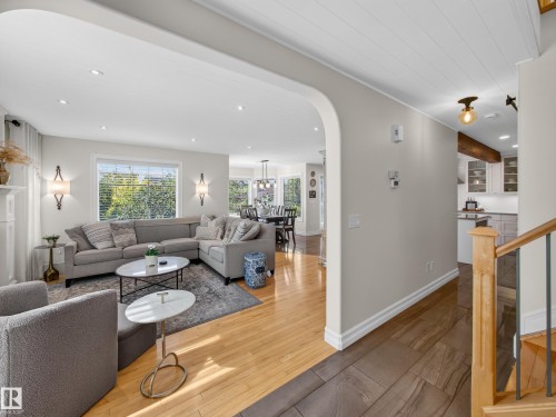 Recessed lighting, wood-finish flooring, staircase with metal balusters, arched entryway, and white shiplap ceiling - 1223 Appleton Close, Sherwood Park, AB 