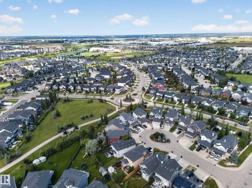 Aerial perspective showcasing a residential community with numerous single-family homes, circular street designs, and interspersed green spaces - 1223 Appleton Close, Sherwood Park, AB 