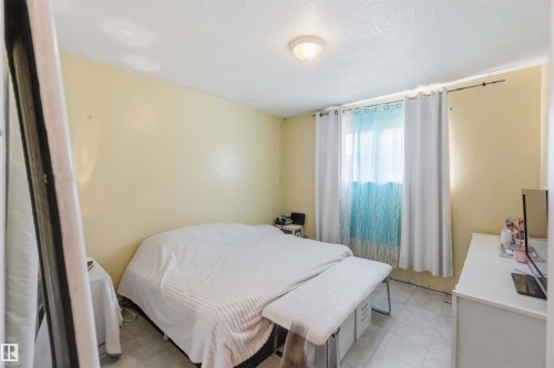 Recessed lighting fixture, light-toned walls, and window with sheer and blackout curtains - 13408 67 Street Nw, Edmonton, AB 
