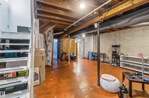 Open unfinished basement featuring exposed ceiling joists, concrete walls, and a finished concrete floor - 13408 67 Street Nw, Edmonton, AB 