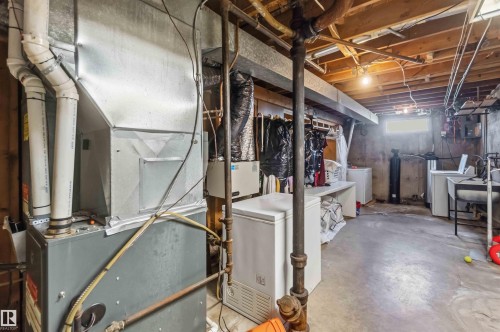Utility room with exposed ceiling joists, concrete flooring, and an egress window - 13408 67 Street Nw, Edmonton, AB 