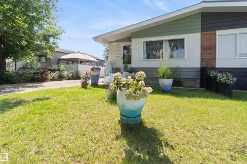 Exterior featuring mixed siding, white trim, and a manicured lawn - 13408 67 Street Nw, Edmonton, AB 