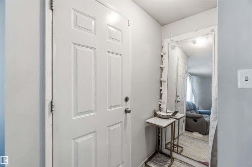 White paneled entry door with round knob, light gray wall, and white trim - 13408 67 Street Nw, Edmonton, AB 