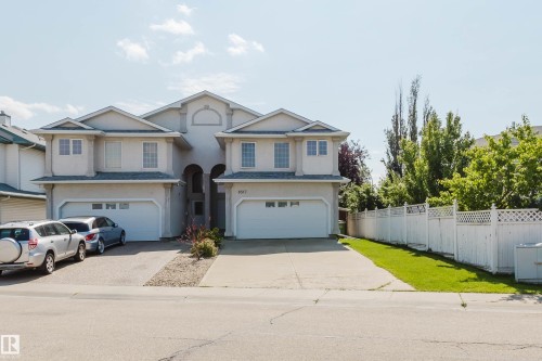 Two-story duplex with attached garages and individual driveways - 8517 156 Avenue Nw, Edmonton, AB 