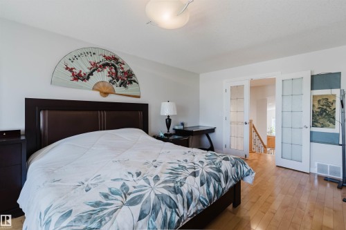 Wood-finish flooring throughout, paired with white walls - 8517 156 Avenue Nw, Edmonton, AB 