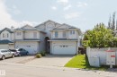 Stucco exterior with multiple gables and arched entryway - 8517 156 Avenue Nw, Edmonton, AB 