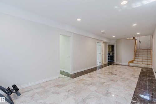 Recessed lighting illuminates the space, featuring a two-tone tile flooring design - 8517 156 Avenue Nw, Edmonton, AB 
