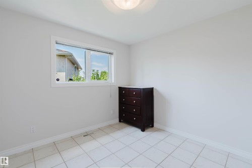 Tile flooring, white painted walls, and an overhead light fixture - 8517 156 Avenue Nw, Edmonton, AB 