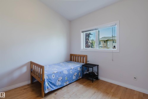 Recessed window with white trim, light-toned walls, and wood-finish flooring - 8517 156 Avenue Nw, Edmonton, AB 
