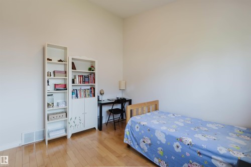Hardwood flooring complements the neutral wall color - 8517 156 Avenue Nw, Edmonton, AB 