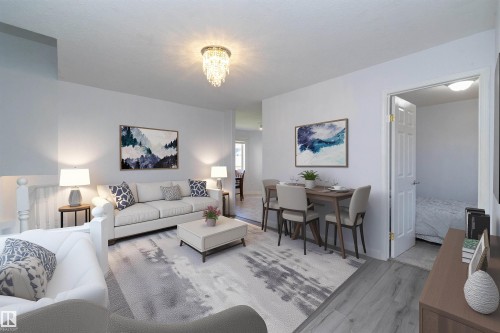 Open-concept living area with wood-finish flooring, a crystal chandelier, and a dining space - #37 3811 85 St Nw, Edmonton, AB 