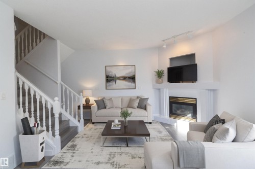 White painted fireplace with a gold-finished insert and mantel - #37 3811 85 St Nw, Edmonton, AB 