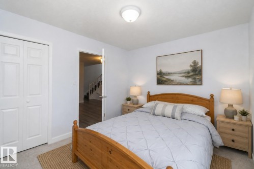 Ceiling-mounted light fixture, white bi-fold closet doors, light-toned walls, and grey carpet flooring - #37 3811 85 St Nw, Edmonton, AB 