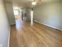 Wood-finish flooring throughout, light gray wall finishes, recessed ceiling light fixtures, and a ceiling fan - 12010 66 Street Nw, Edmonton, AB 