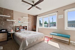 Ceiling fan with integrated lighting, multiple windows, wood-finish flooring, and built-in shelving - 