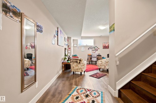 Wood-finish flooring, white trim, and a horizontal window - 10833 63 Avenue Nw, Edmonton, AB 