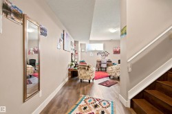 Wood-finish flooring, white trim, and a horizontal window - 