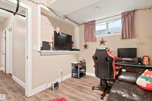 Wood-finish flooring, white trim, a built-in display nook, recessed lighting, and a window with a valance - 10833 63 Avenue Nw, Edmonton, AB 