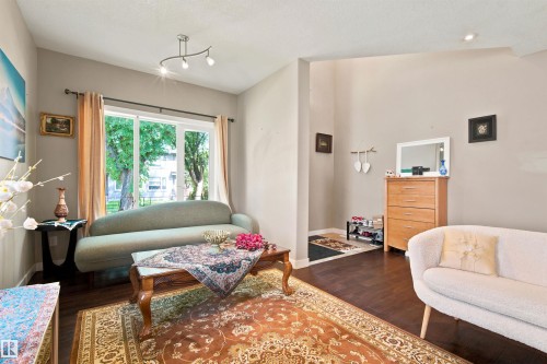 Hardwood-style flooring throughout, complemented by light-toned wall finishes - 10833 63 Avenue Nw, Edmonton, AB 