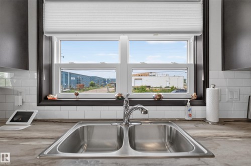 Dual-basin stainless steel sink with a chrome faucet - 4204 47 Street, Wetaskiwin, AB - Indoor Photo Showing Kitchen With Double Sink