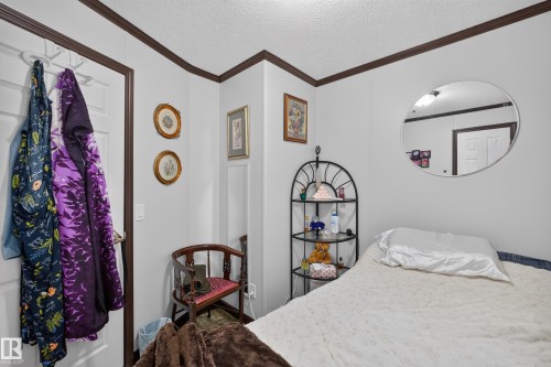 White interior walls complemented by dark brown trim - 4204 47 Street, Wetaskiwin, AB - Indoor Photo Showing Bedroom