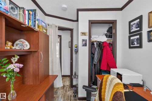 Interior space featuring wood-finish flooring, white walls, and dark brown trim - 4204 47 Street, Wetaskiwin, AB - Indoor Photo Showing Other Room
