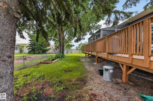 Expansive exterior deck featuring natural wood railing and support beams - 4204 47 Street, Wetaskiwin, AB - Outdoor With Deck Patio Veranda