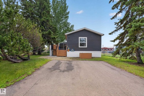 Modern single-story residence featuring dark siding and white trim - 4204 47 Street, Wetaskiwin, AB - Outdoor
