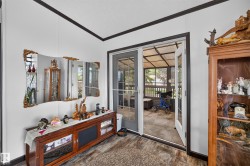 Glass-paneled French doors opening to a sunroom with a white railing - 