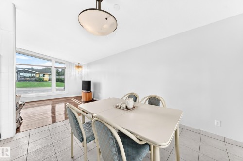 Recessed ceiling light fixture, tile flooring, wood-finish flooring, large picture windows, and pendant lighting - 3311 104 Avenue Nw, Edmonton, AB 