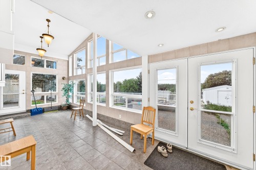 Sunroom with expansive windows, recessed lighting, and tile flooring - 3311 104 Avenue Nw, Edmonton, AB 