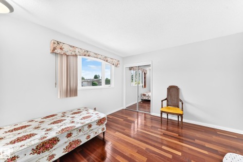 Wood-finish flooring, white walls, and a window with blinds and valance - 3311 104 Avenue Nw, Edmonton, AB 