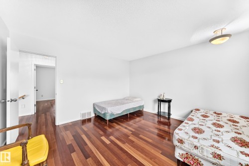 Hardwood-finish flooring, white walls, and a semi-flush mount ceiling light - 3311 104 Avenue Nw, Edmonton, AB 