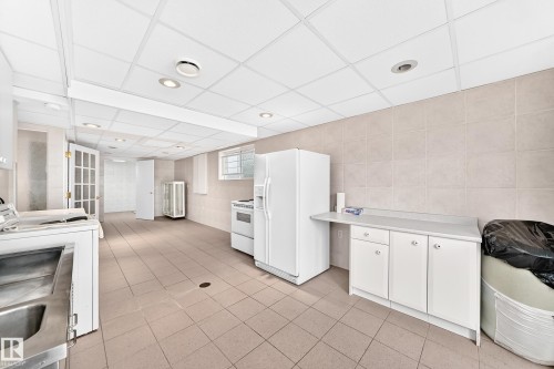 Tile flooring, white cabinetry, tile wall, recessed lighting, and a drop ceiling - 3311 104 Avenue Nw, Edmonton, AB 
